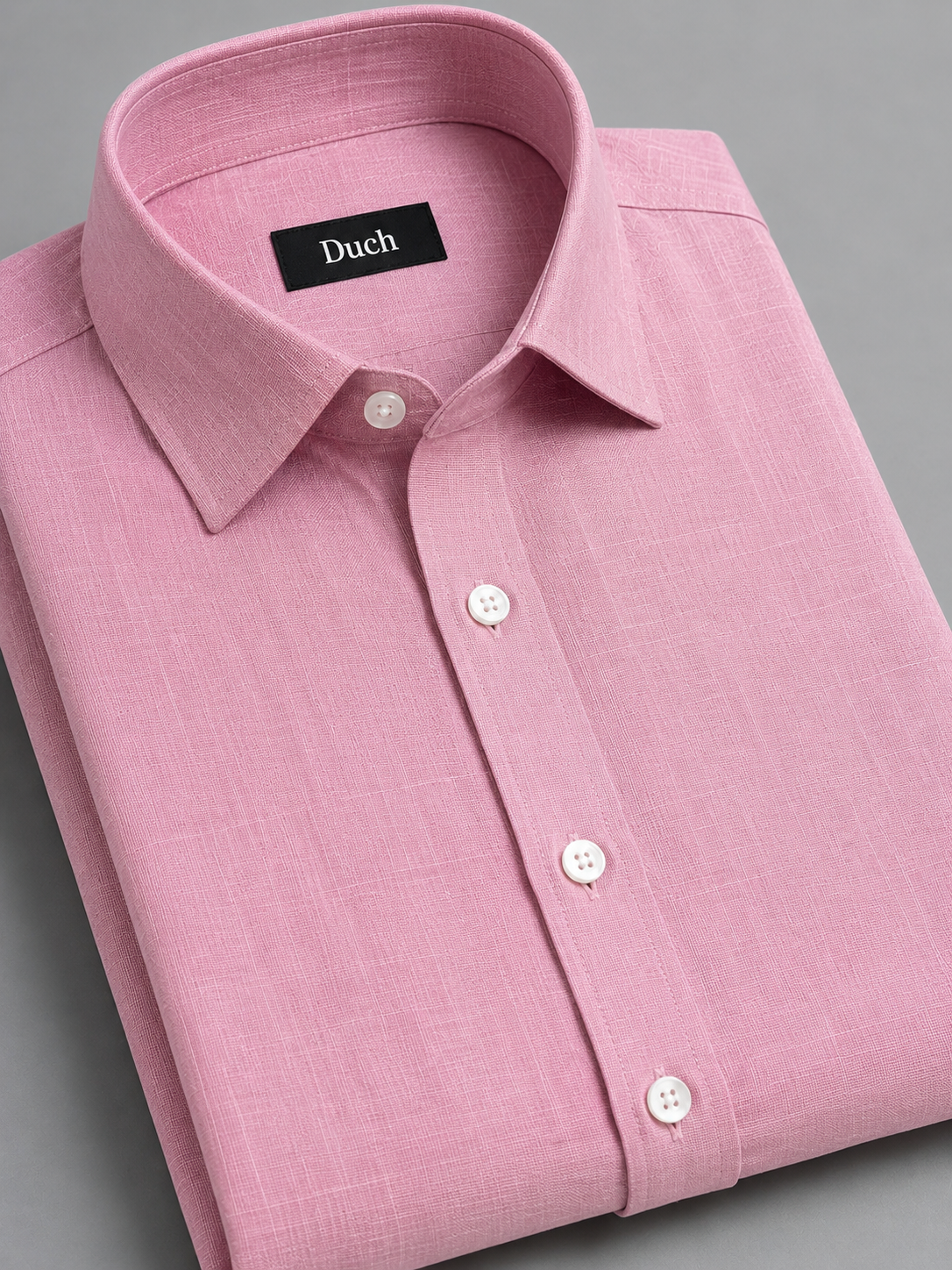 Baby pink linen shirt folded – collar and button detail | Duch Clothing