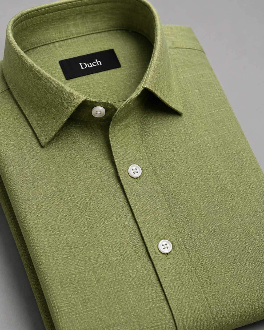 Sage green linen shirt folded – collar and button detail | Duch Clothing