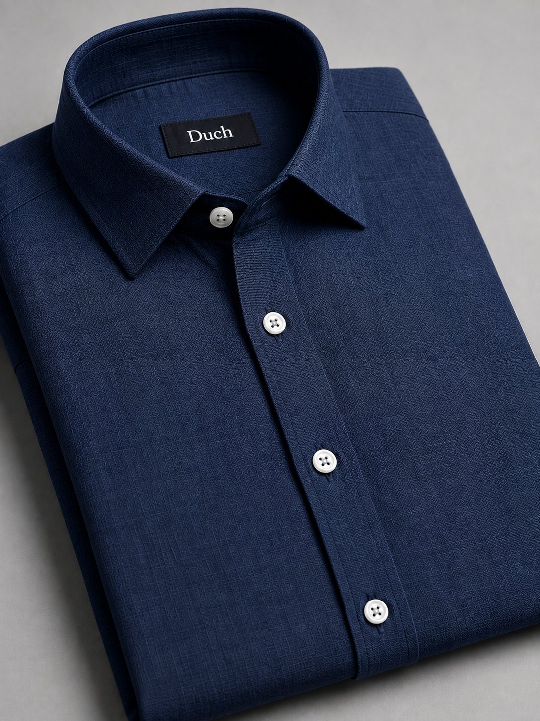 Navy blue linen shirt folded – collar and button detail | Duch Clothing